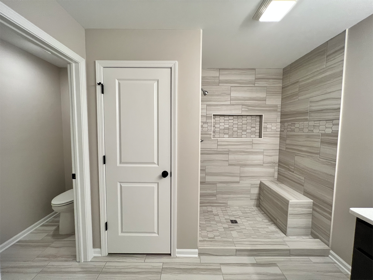 The Franklin master bathroom with ceramic floors, tile shower, linen closet and toilet
