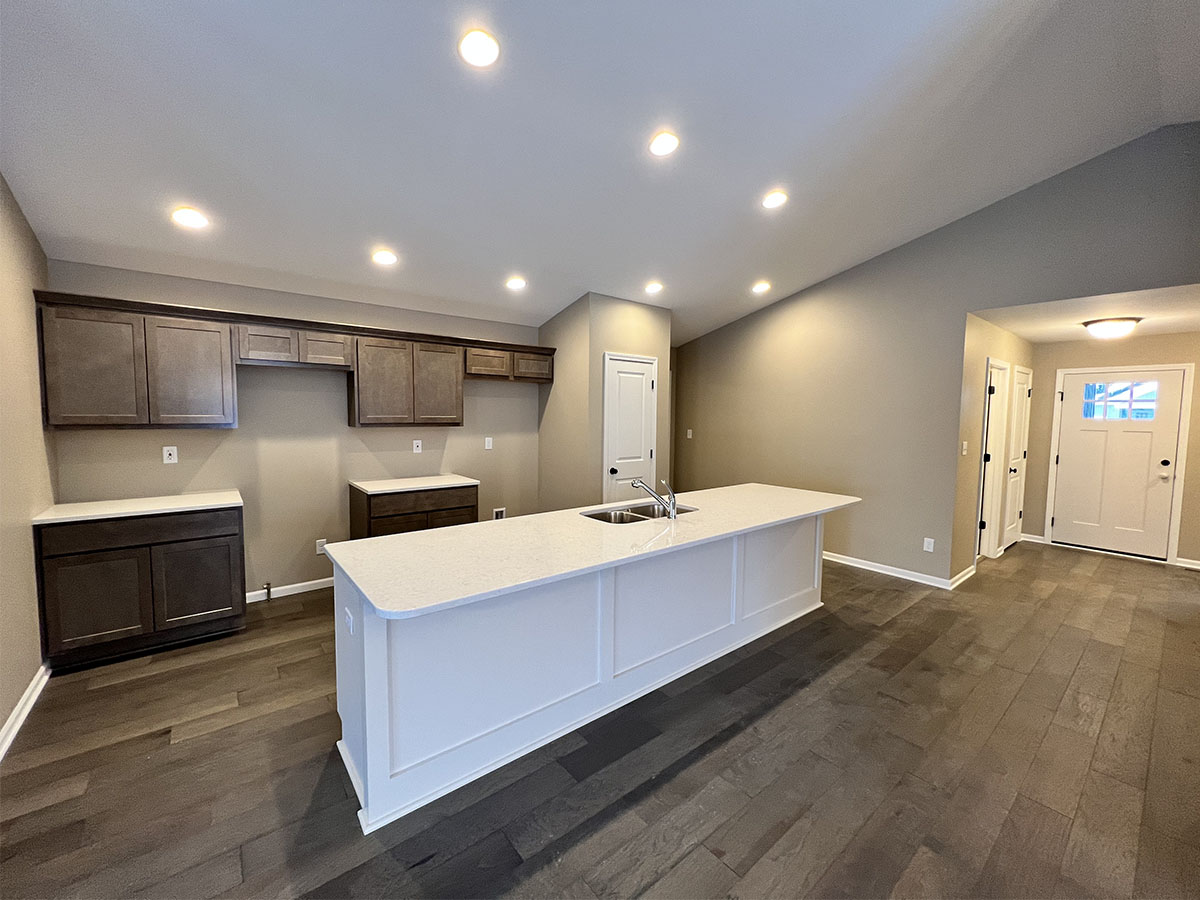Kitchen with white counter tops and dark wood