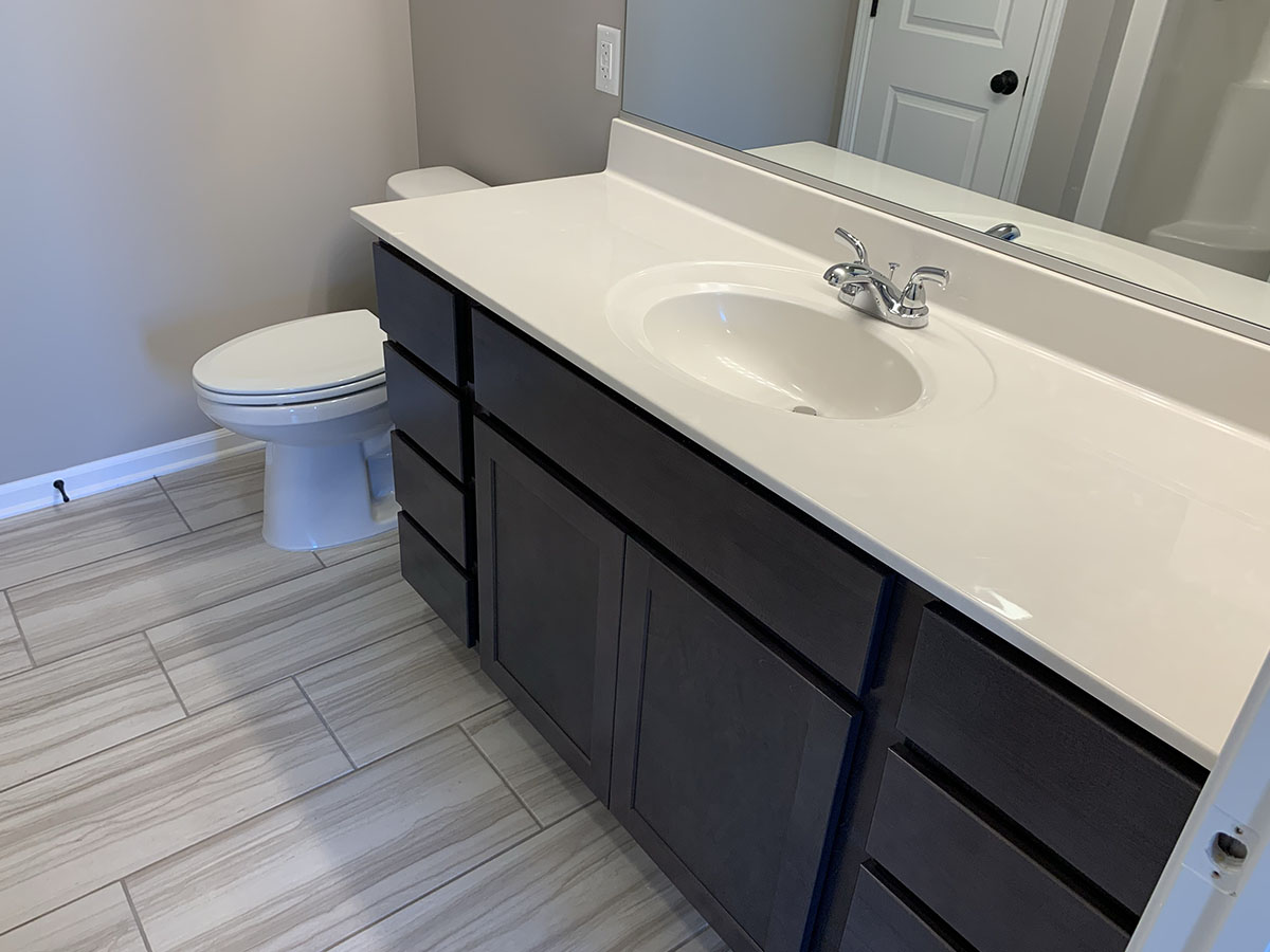 Master bathroom sink, toilet, and tile floor