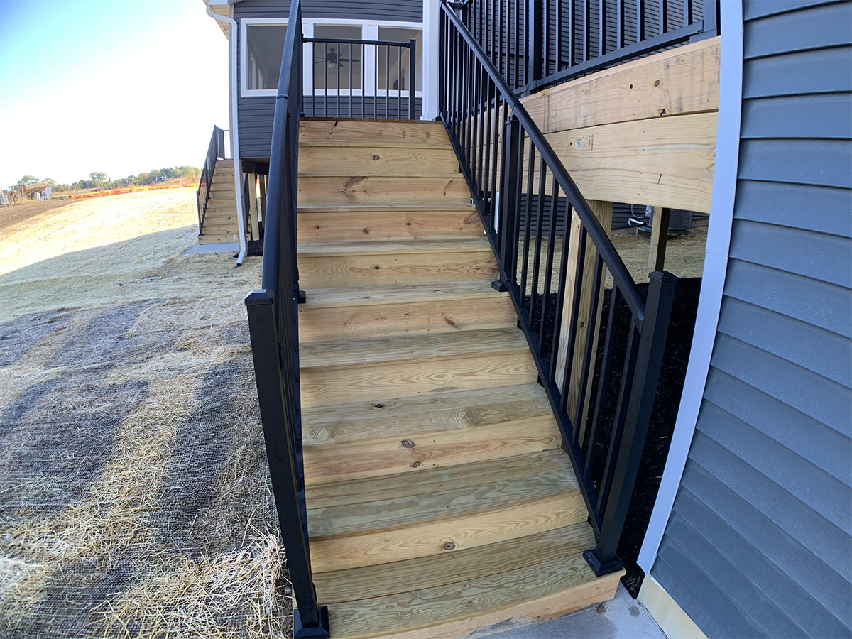 Stairs going up to the covered wooden porch