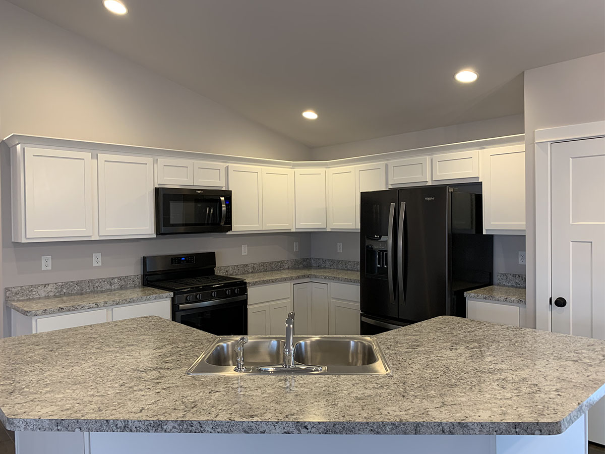 The Harrison kitchen with granite counter tops and white cabinets