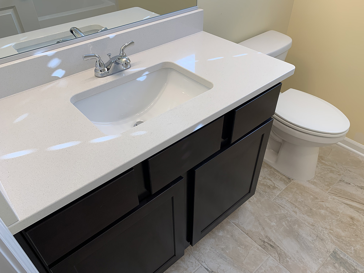 Second bathroom white sink with dark vanity