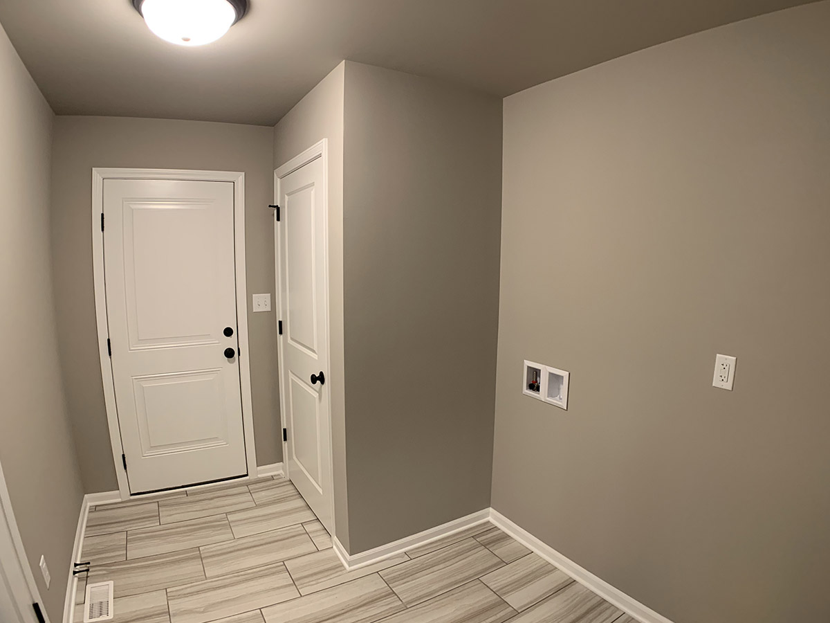 Laundry room with tile floor and closet