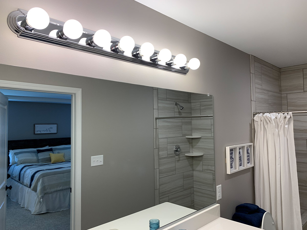 Master bathroom with mirror and multi-bulb lights