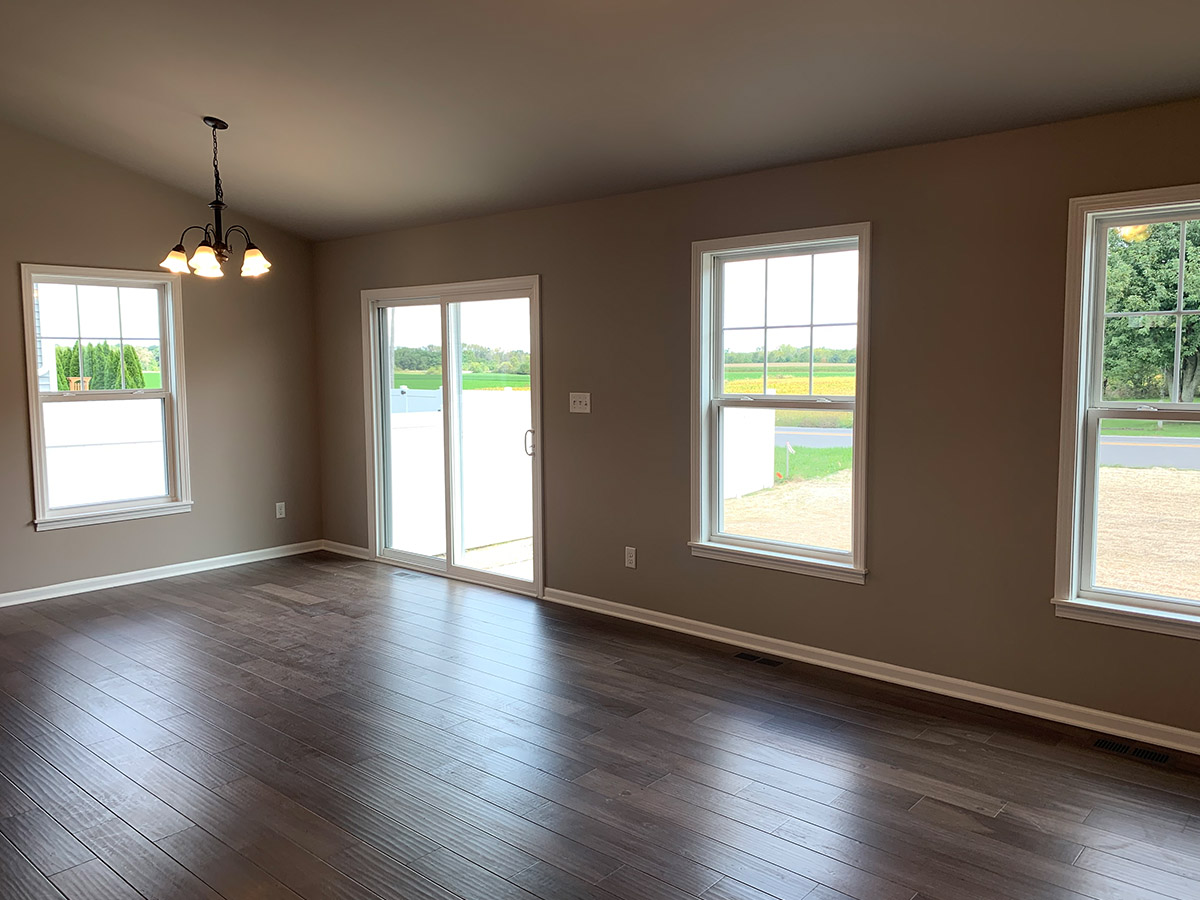 The Stockton family room with 3 windows and glass sliding door