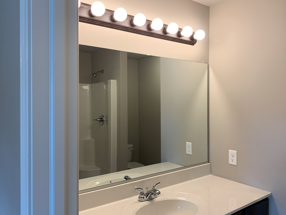 Master bathroom sink, mirror, and multi-bulb lights