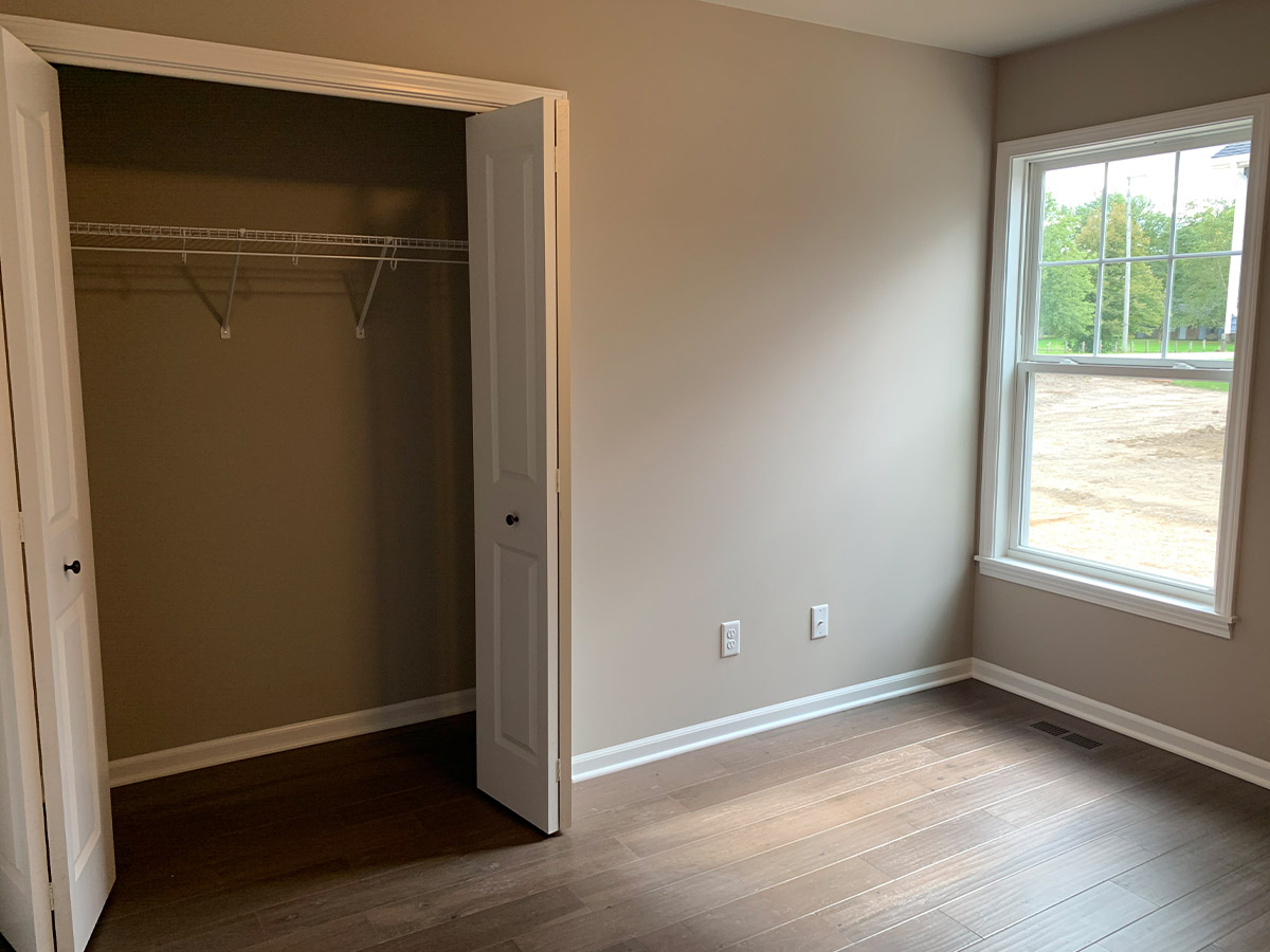 Bedroom with one window and bi-fold door closet