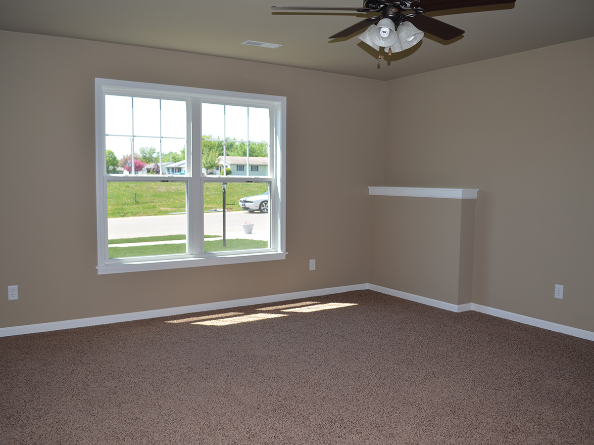 Family room with carpet floor and double hung windows