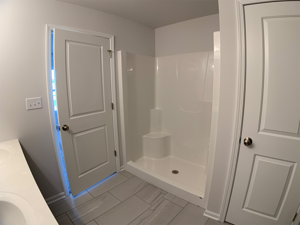 The Churchill master bathroom with ceramic floors and fiberglass shower