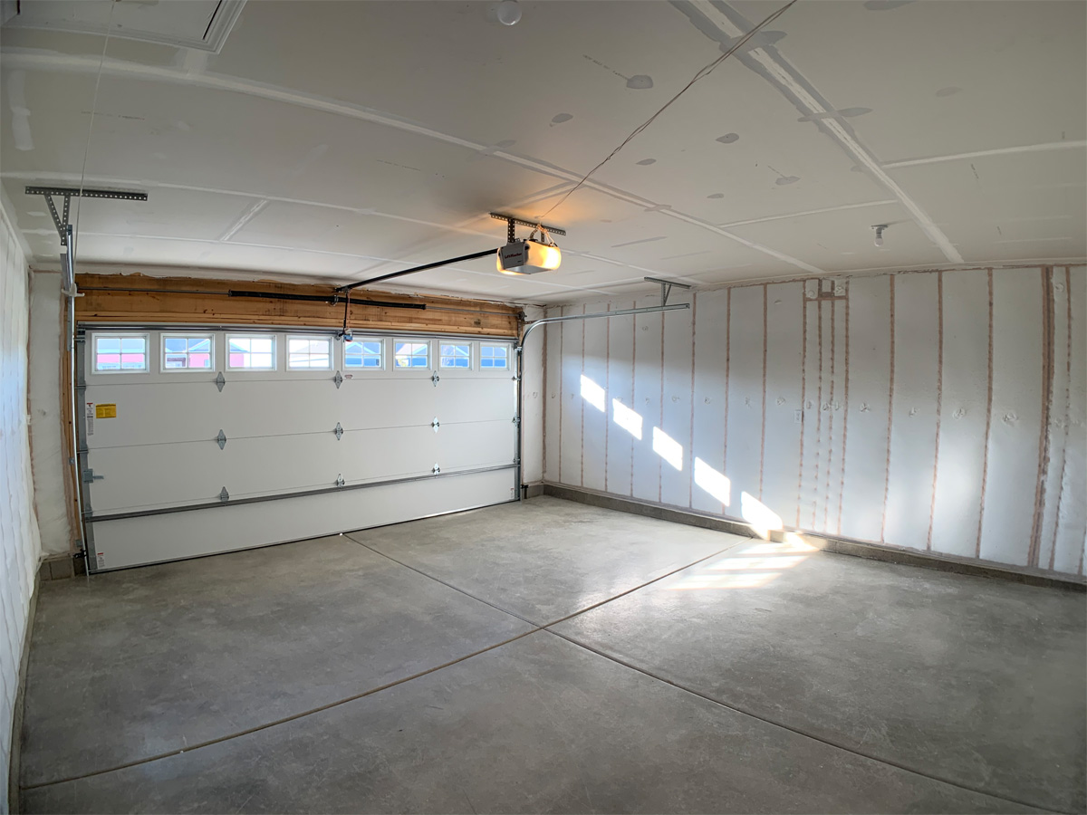 The Churchill garage with concrete floors and garage door