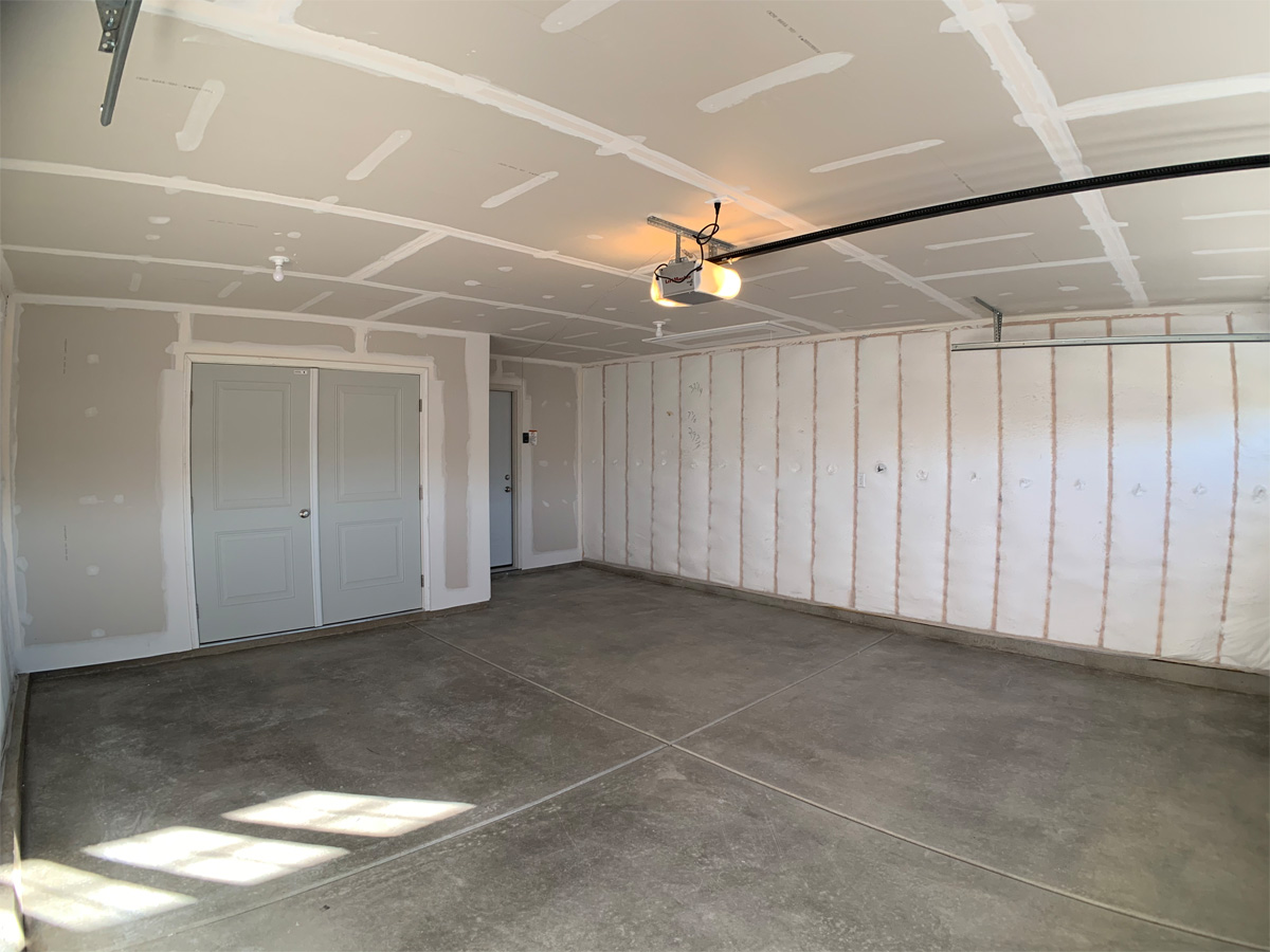 The Churchill garage with concrete floors and utility room closet