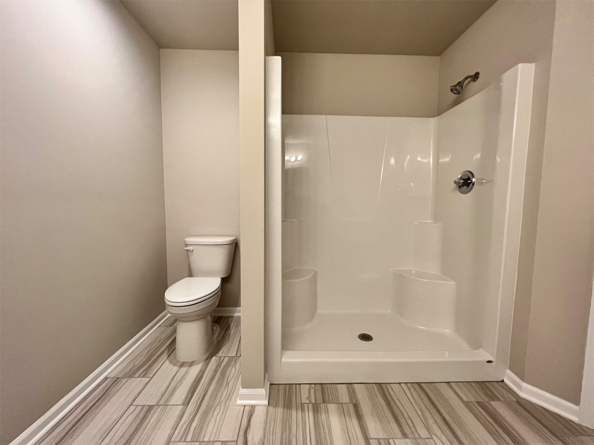 The Middleton master bathroom fiberglass shower and toilet