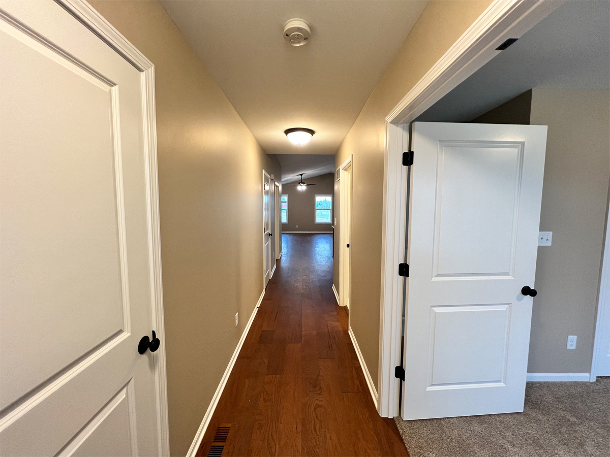 The Redbud hallway with hardwood floors