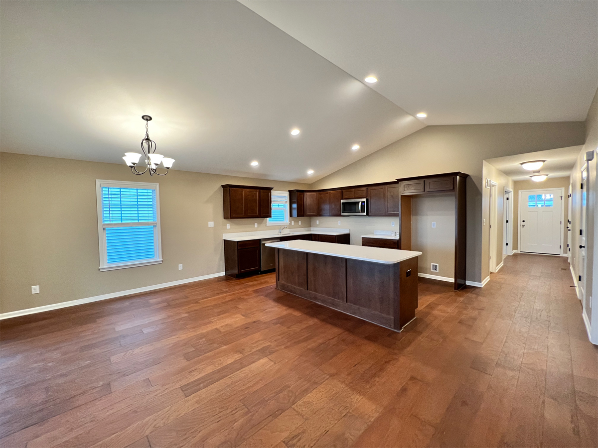 The Redbud kitchen with hardwood floors, cabinets and appliances