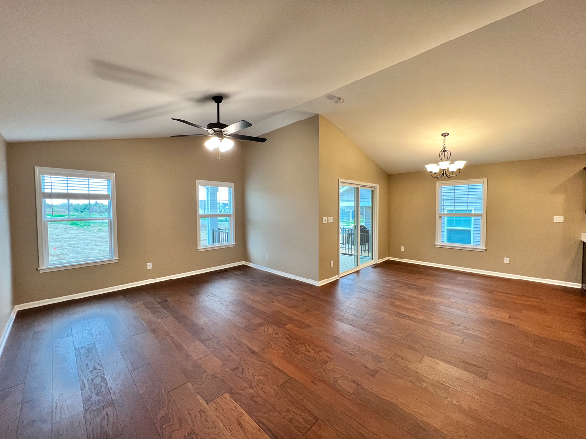 The Redbud living room and dining room with hardwood floors and ceiling fan