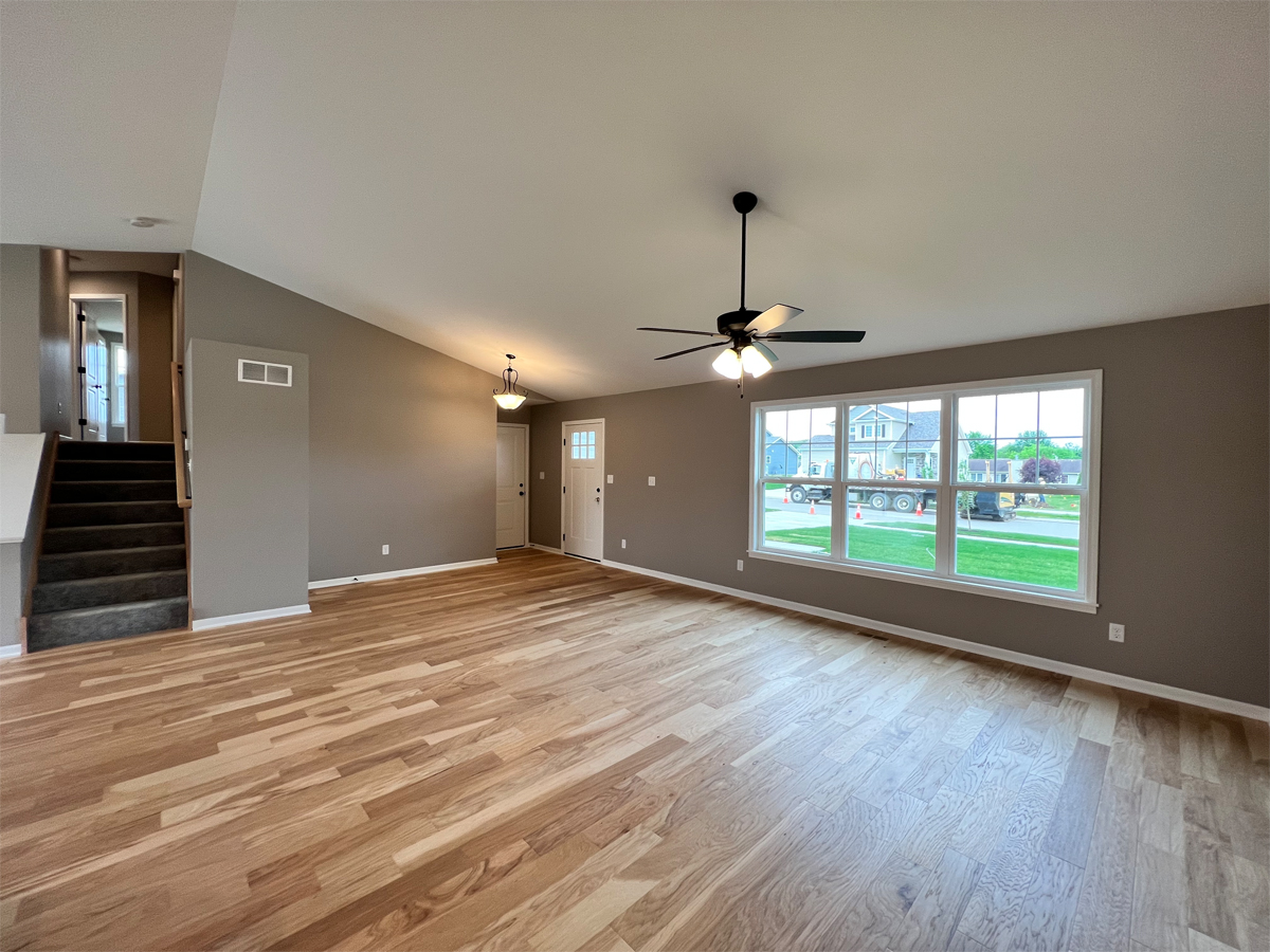 The Revere family room with hardwood floors, ceiling fan and triple window