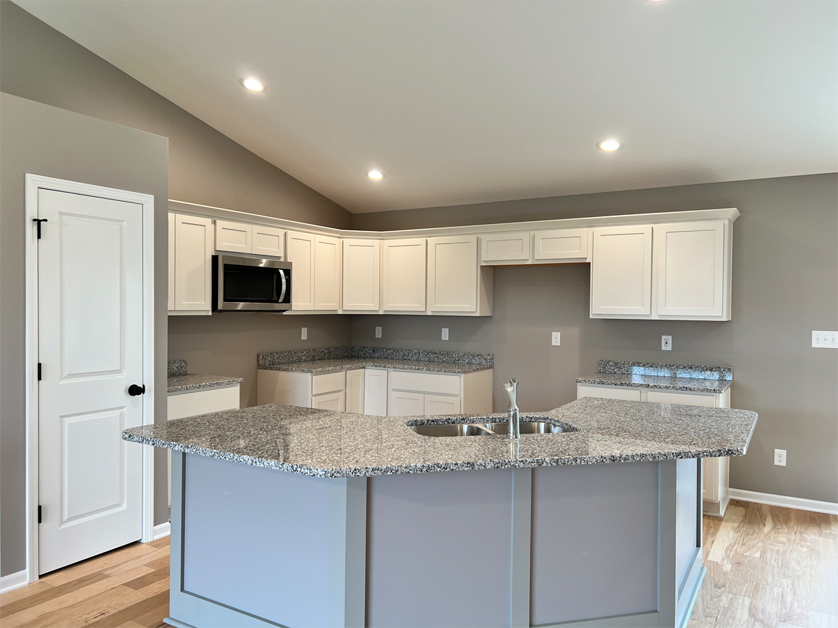 The Revere kitchen with cabinets, appliances and granite countertops