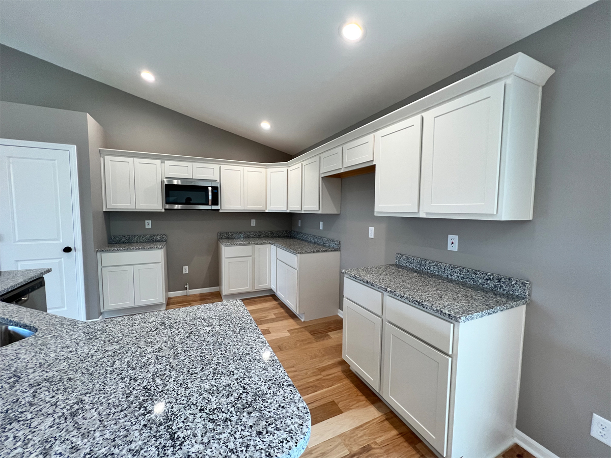 The Revere kitchen with cabinets, appliances and granite countertops