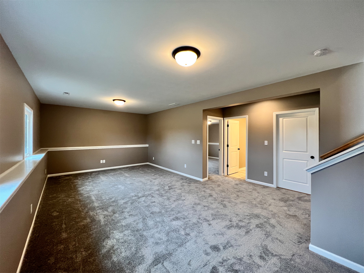 The Revere lower level family room with carpet and ledge