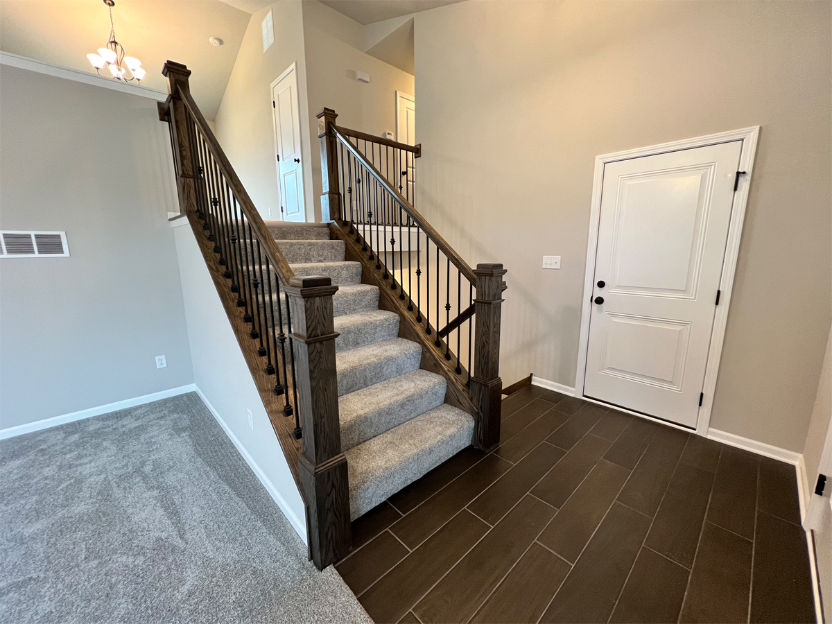 The Washington entry with ceramic floors, carpet and staircase to main level