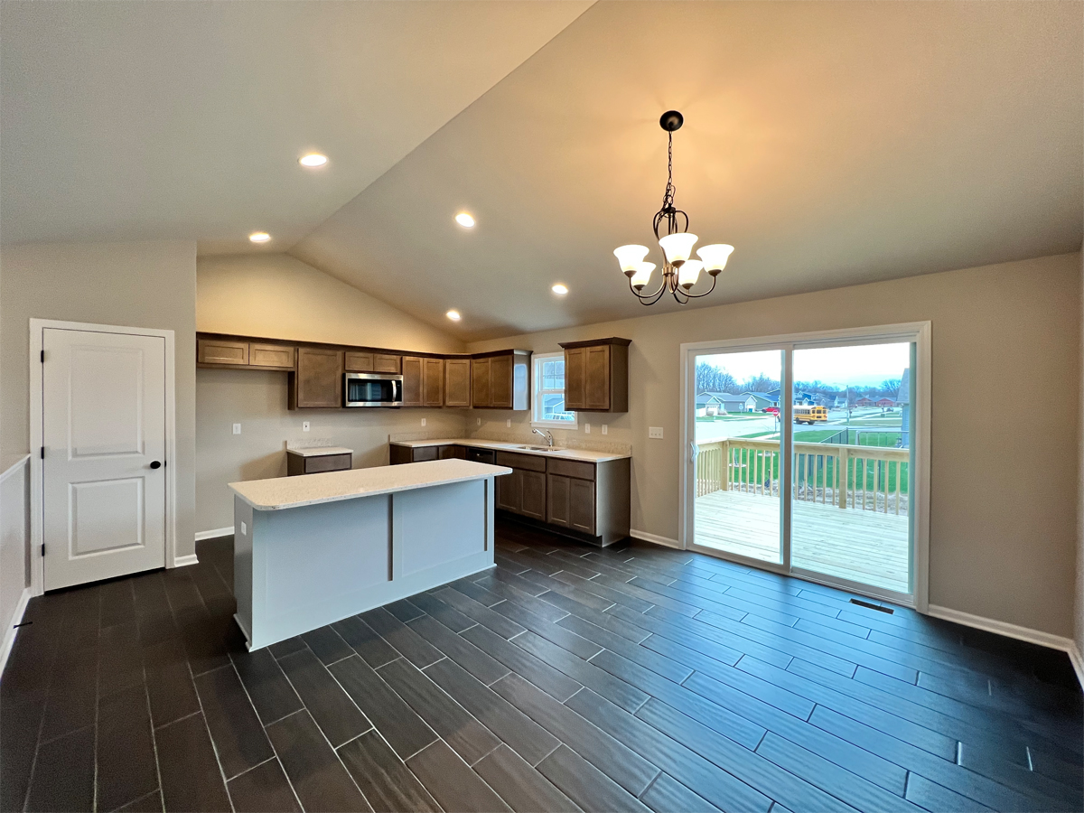 The Washington kitchen with ceramic floors, cabinets, appliance and sliding door to deck