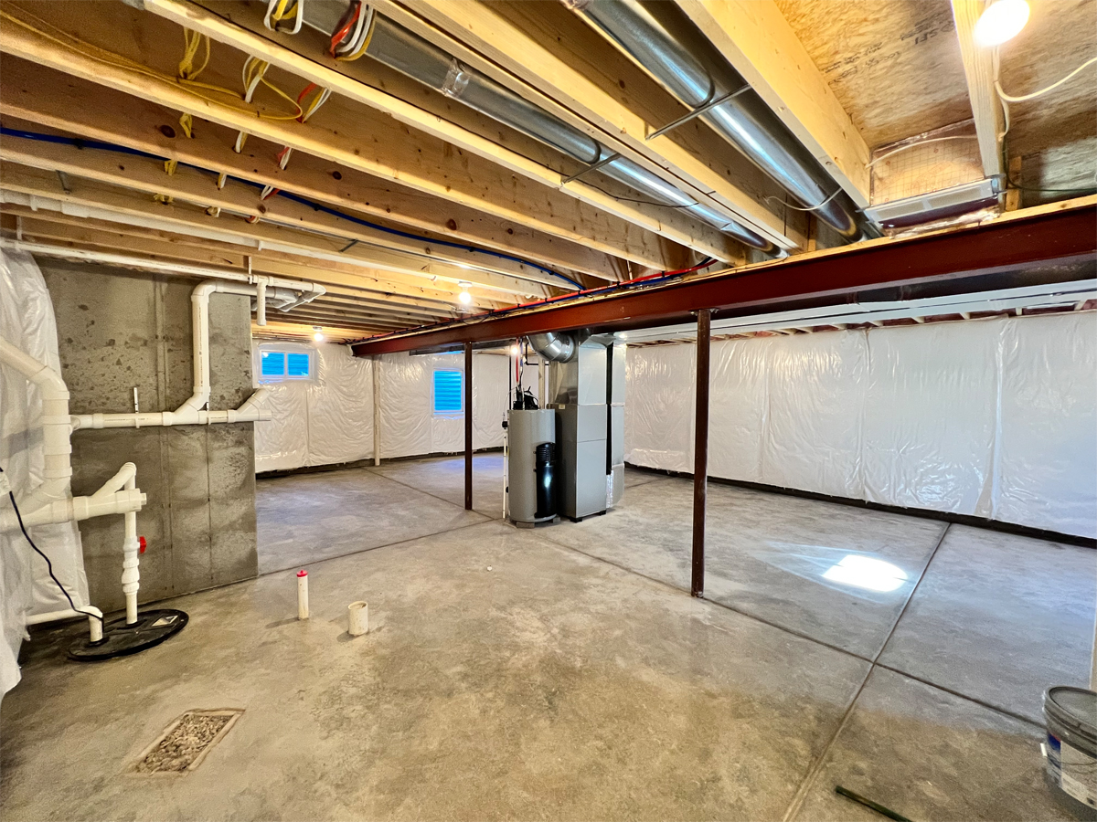 The Adams full basement with utilities and concrete floors