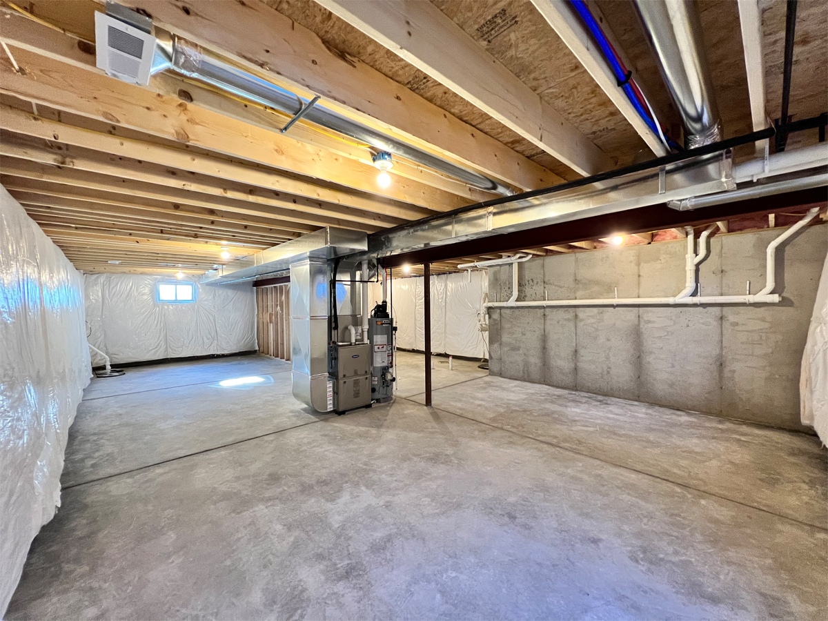 The Adams basement with utilities and concrete floors