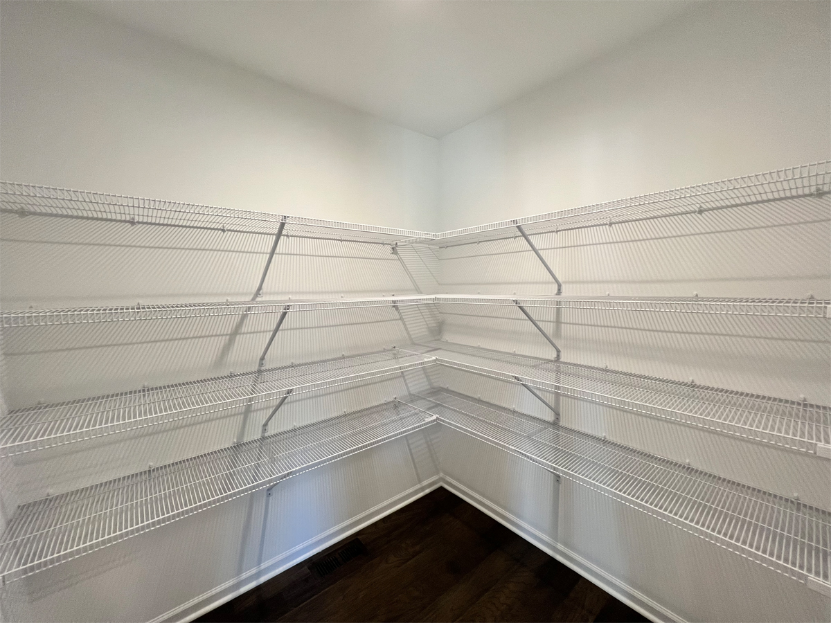 The Sherman pantry with wire shelving and hardwood floors