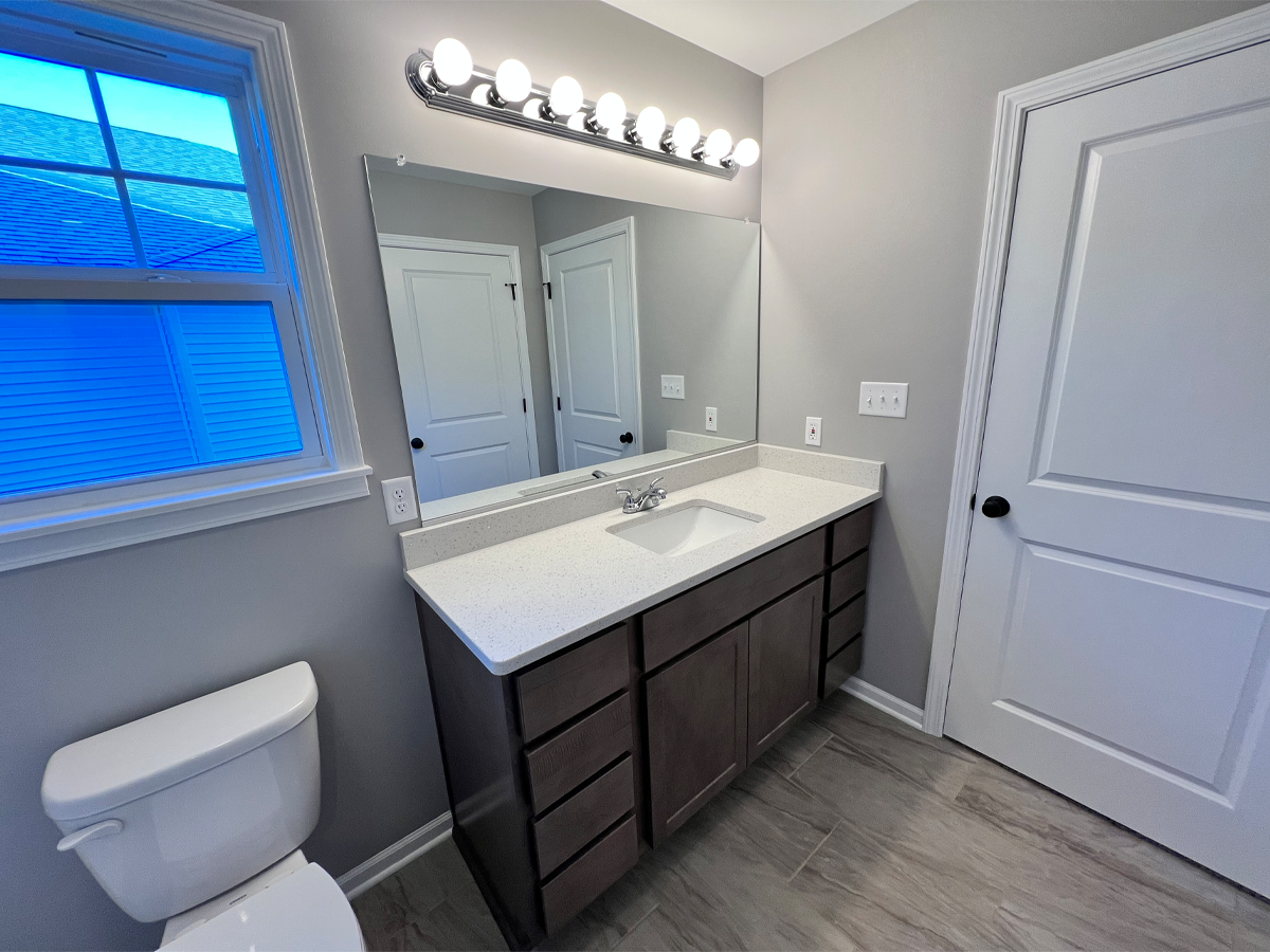 Juniper master bathroom with ceramic floors and vanity