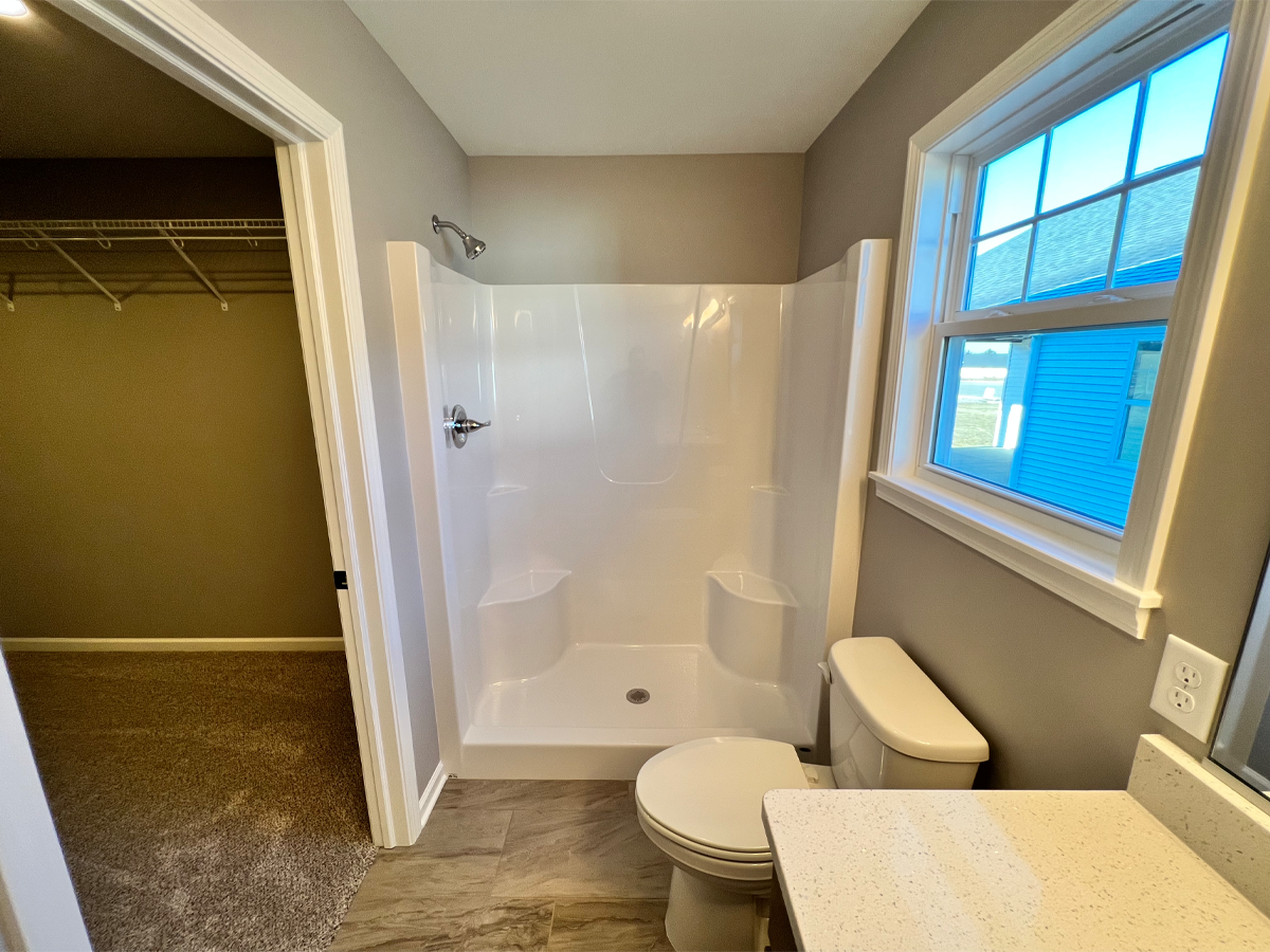 Juniper master bathroom with fiberglass shower and toilet