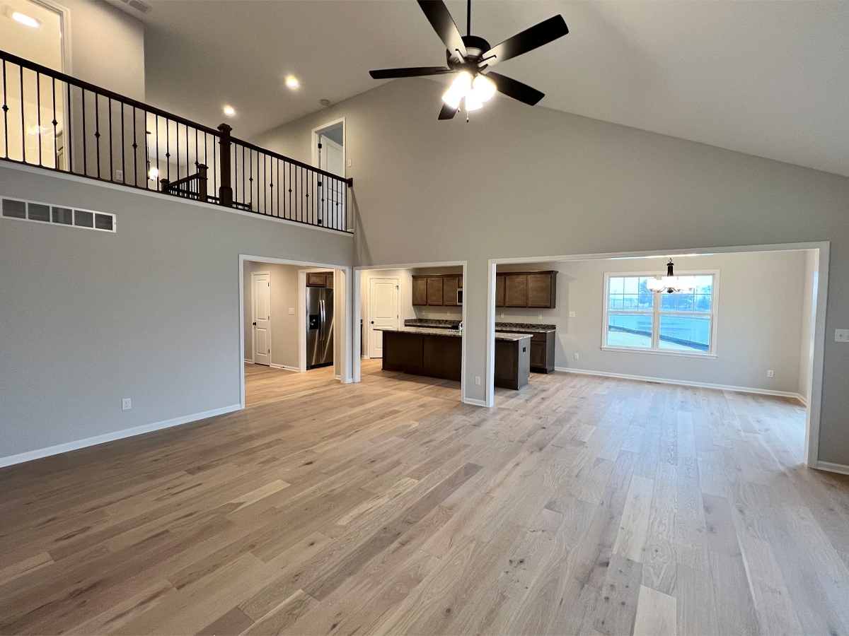 The Walton living room with hardwood floors and access to kitchen