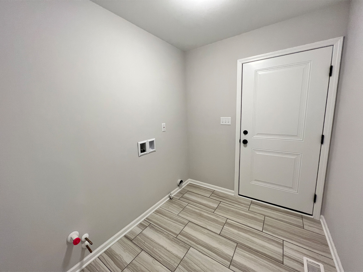 The Walton laundry room with garage access and ceramic floors