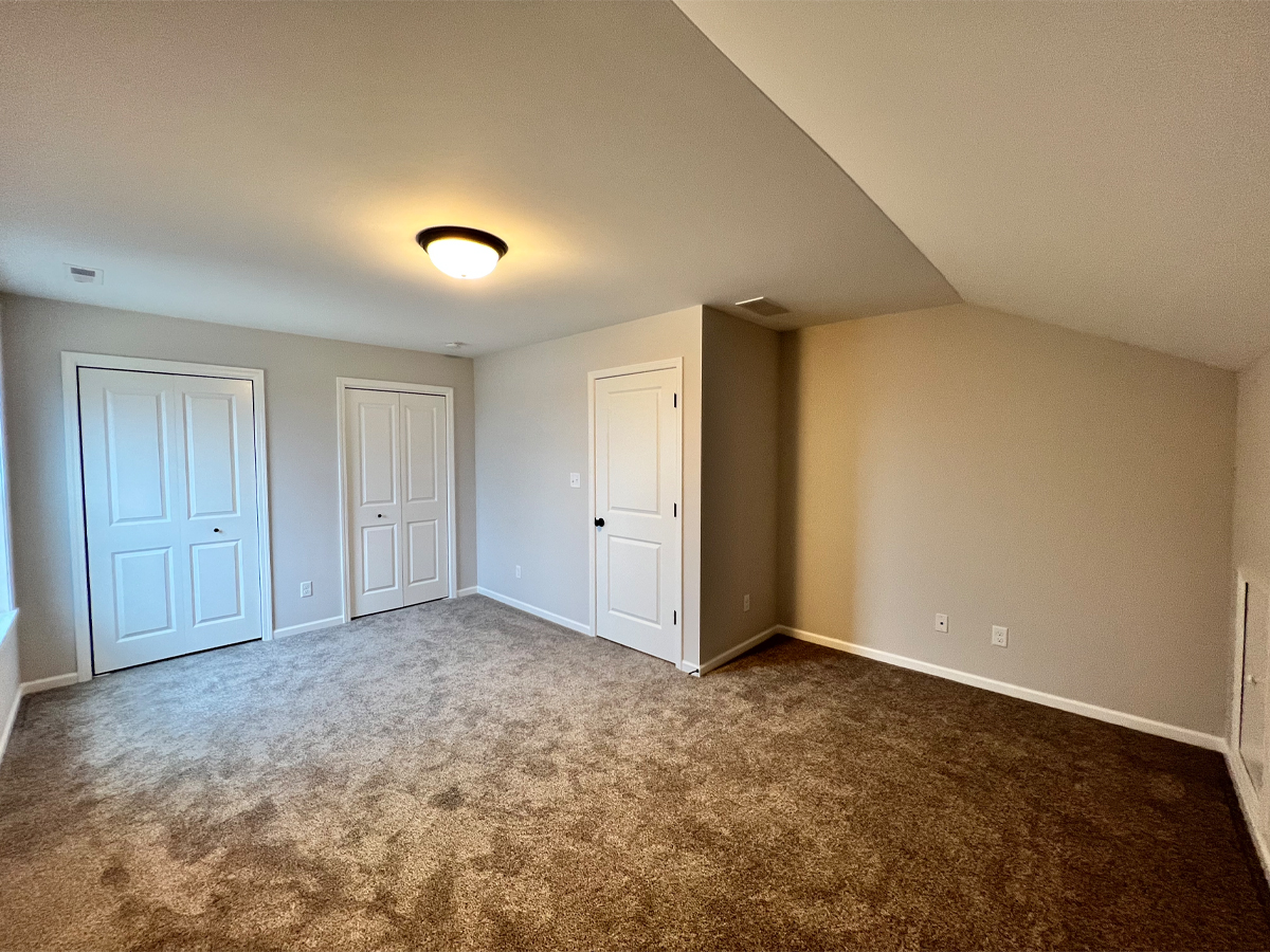 The Walton second bedroom with carpet and closets